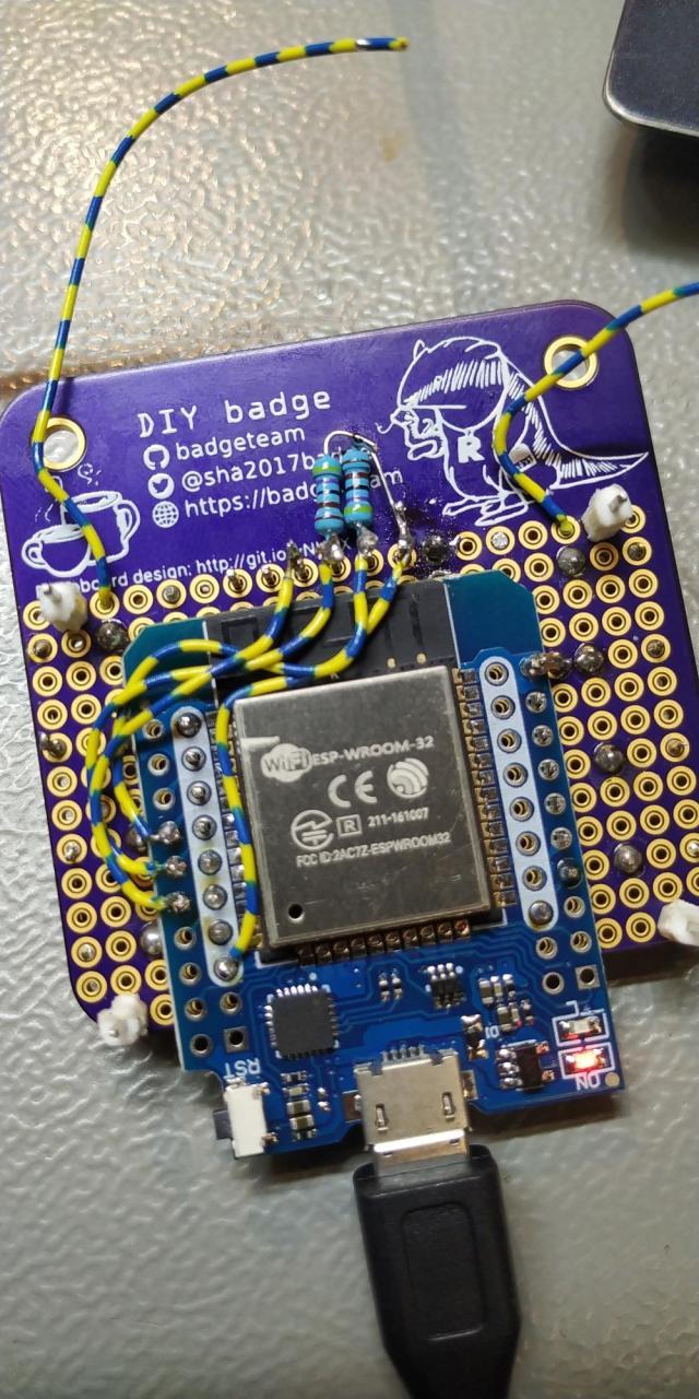 Back of the badge, with two pullup resistors floating on the header pins